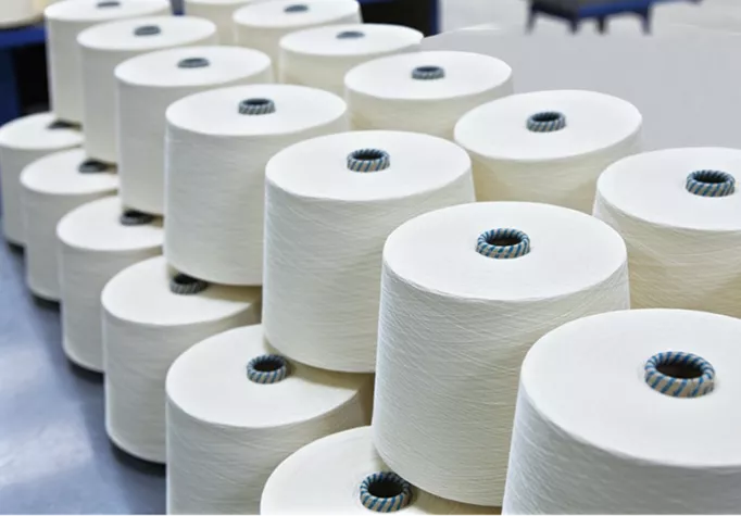 Polyester spun yarn for continuous textile production